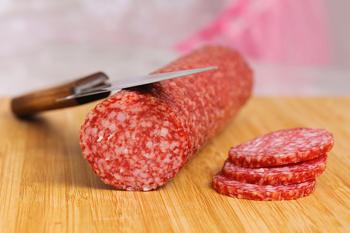 smoked meat salami lying on a table. Selective focus technique