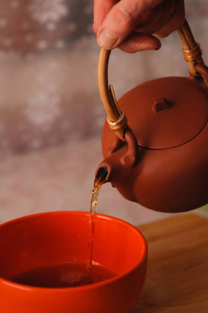istock pouring tea from teapot into a mug 1199158344