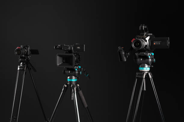 three different types of video cinema photo camera on black background - television camera tripod media equipment videography imagens e fotografias de stock