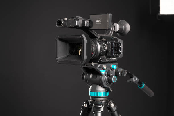 istock Professional 4K video camera on camera tripod and lighting LED panel 1199165627