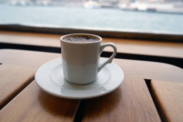 istock A white plain cup of frothy Turkish coffee on a wooden table. 1199166619