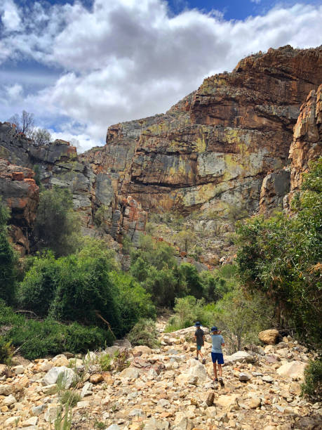 istock Hiking on rocks towards cliff face 1199166688