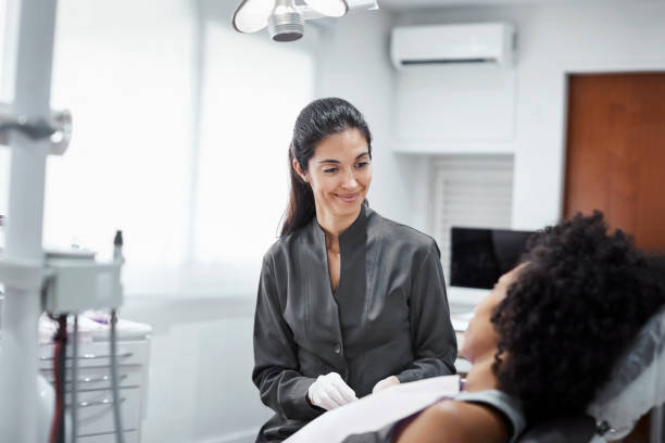 istock Confident dentist discussing with patient 1199167406