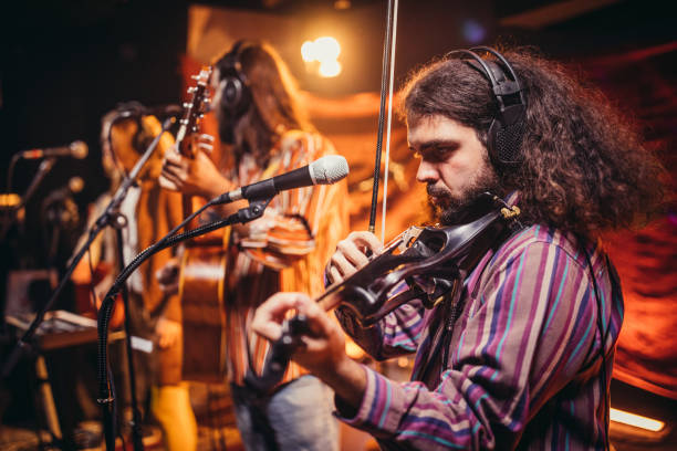 istock Violinist performing on stage with band 1199170175