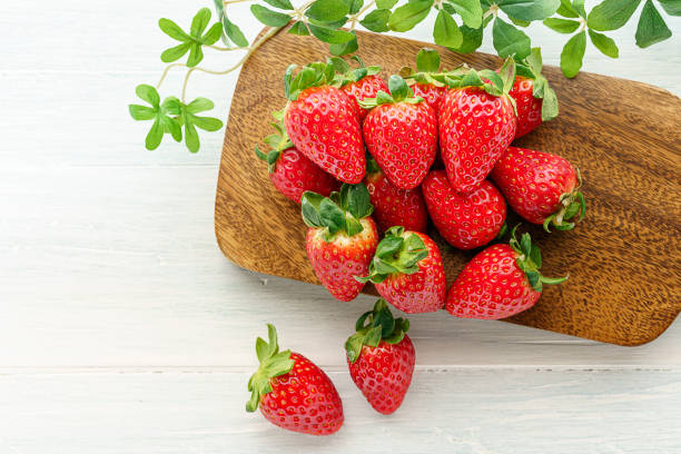 istock Fresh strawberry isolated on wooden background 1199170763