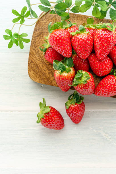 istock Fresh strawberry isolated on wooden background 1199170777