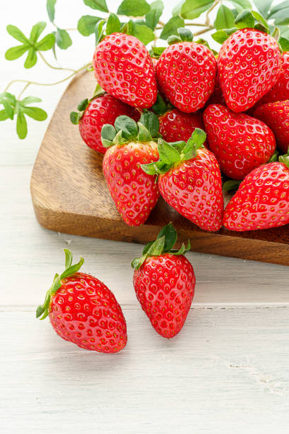 istock Fresh strawberry isolated on wooden background 1199170819
