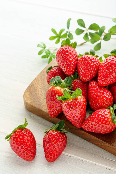 istock Fresh strawberry isolated on wooden background 1199170828