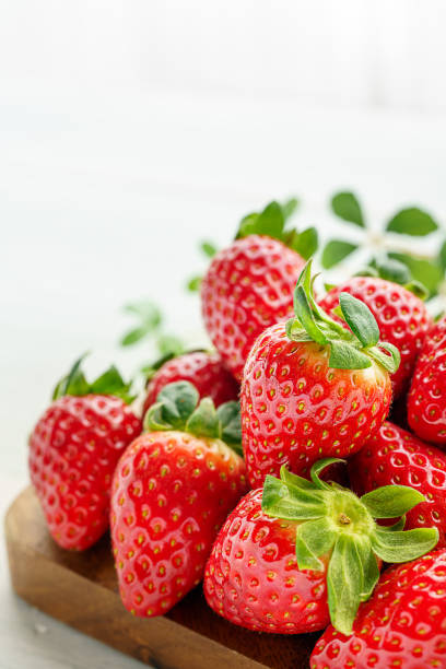 istock Fresh strawberry isolated on wooden background 1199170863