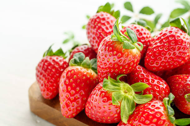 istock Fresh strawberry isolated on wooden background 1199170882