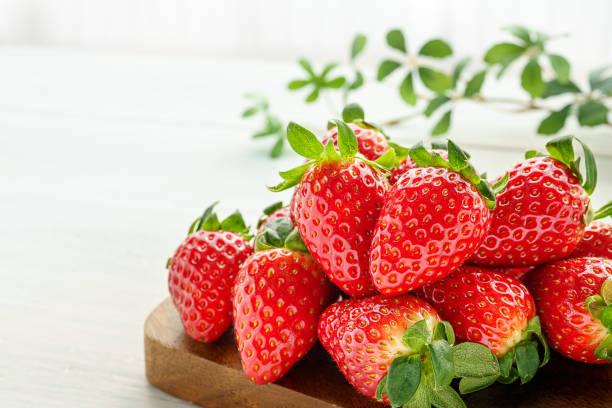 istock Fresh strawberry isolated on wooden background 1199170944