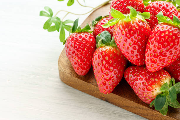 istock Fresh strawberry isolated on wooden background 1199170958