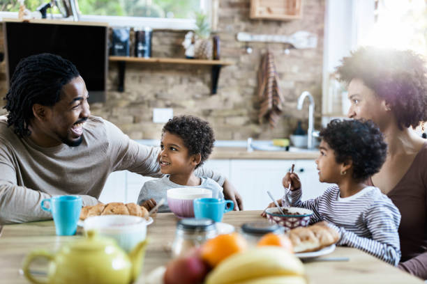 istock Happy black family talking while having breakfast in the morning. 1199170962