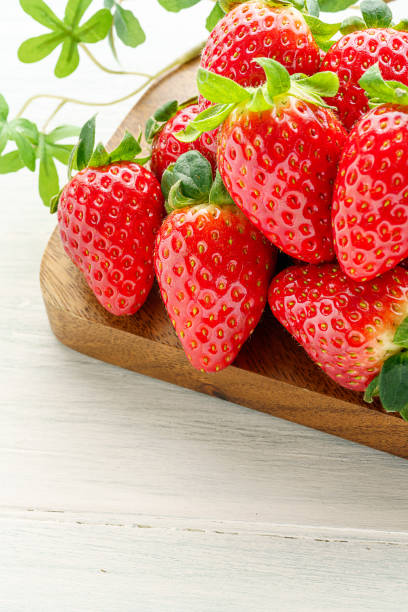 istock Fresh strawberry isolated on wooden background 1199170976