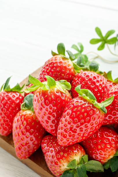 istock Fresh strawberry isolated on wooden background 1199170988