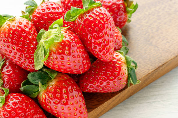 istock Fresh strawberry isolated on wooden background 1199171010