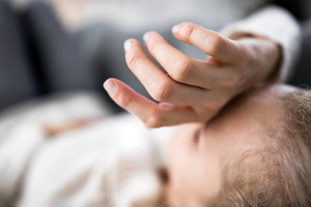 Woman with sinuses problem, stomach, chest and head issues at home on a couch, being sick.