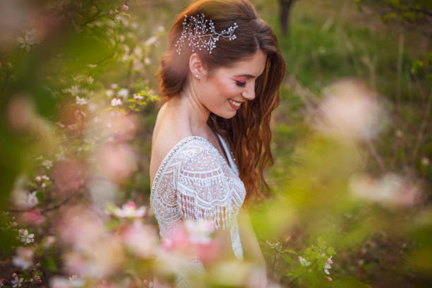 Bride to be Portrait of a beautiful bride posing in a blossoming orchard. bridal hair stock pictures, royalty-free photos & images