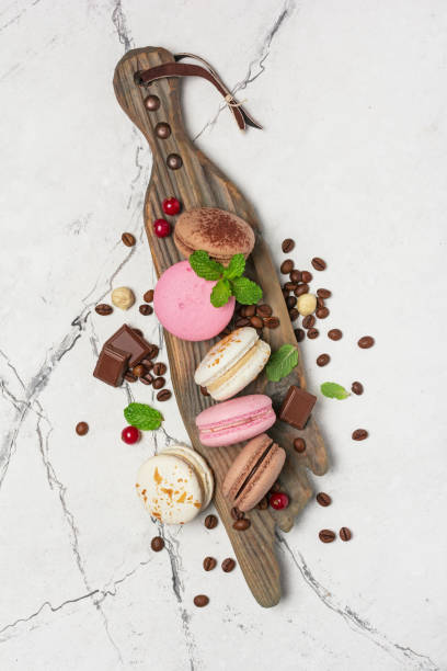 istock French dessert macaroons with coffee beans, nuts, chocolate and berries 1199172901