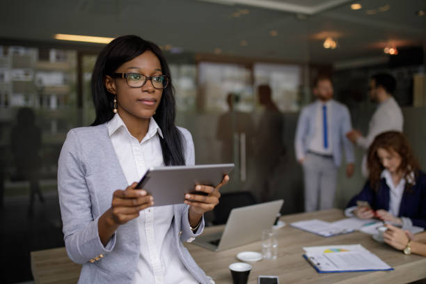 istock Young businesswoman using digital tablet in the office 1199173080
