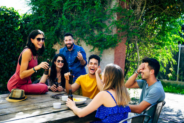 istock Spanish friends relaxing outdoors with beers and snacks 1199175540