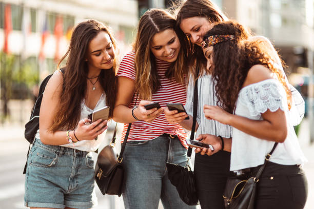 istock teens using the smartphone in the city 1199175888