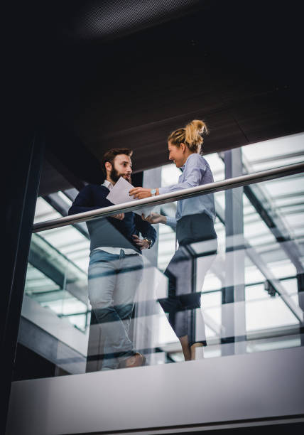 istock Two business people discussing on the hallway 1199175907