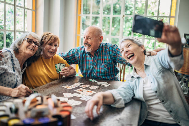istock Senior friends taking a selfie while playing cards 1199177956
