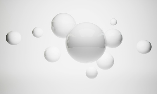 Shiny balls with different size on simple gradient background. Glossy bubbles in empty space. Abstract composition with chaotic floating spheres. 3d rendering