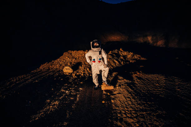 istock Astronaut standing alone on dark planet 1199183835