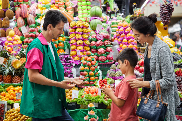 istock Vendor guiding customer in choosing fresh fruit 1199183857