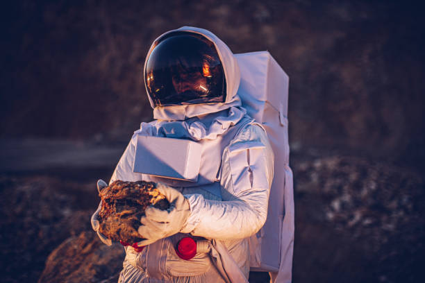istock Astronaut holding a rock on Mars 1199188628
