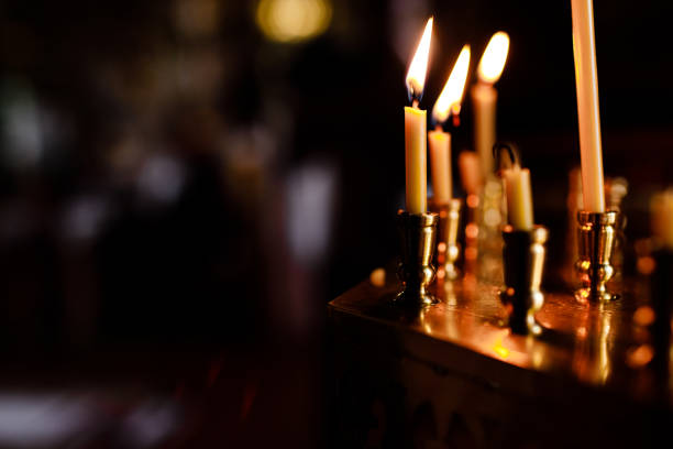 istock burning candles in church on dark background 1199189941