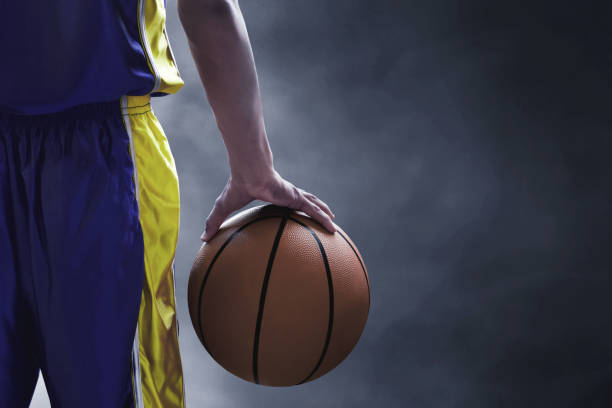 istock Basketball player holding a ball 1199190701