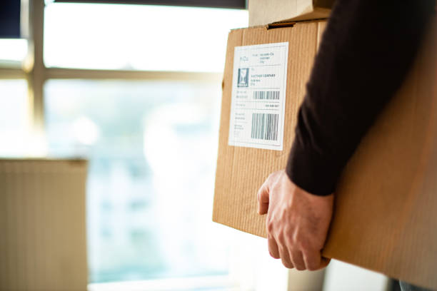 istock Young man carrying packages for shipment 1199190713