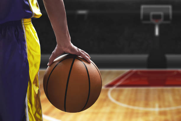 istock Basketball player holding a ball 1199191444