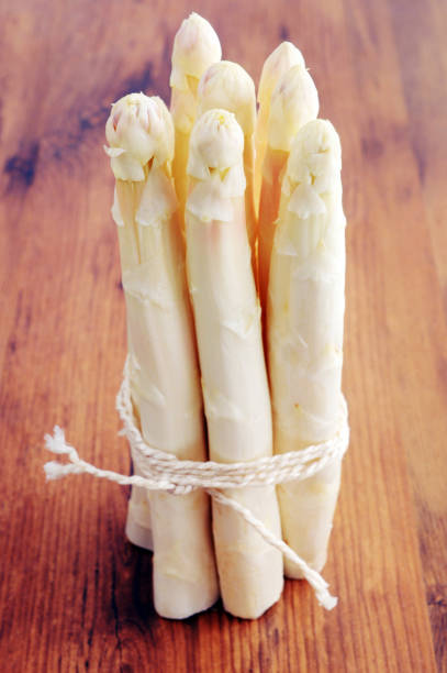 istock fresh Bunch of white asparagus on table background 1199191478