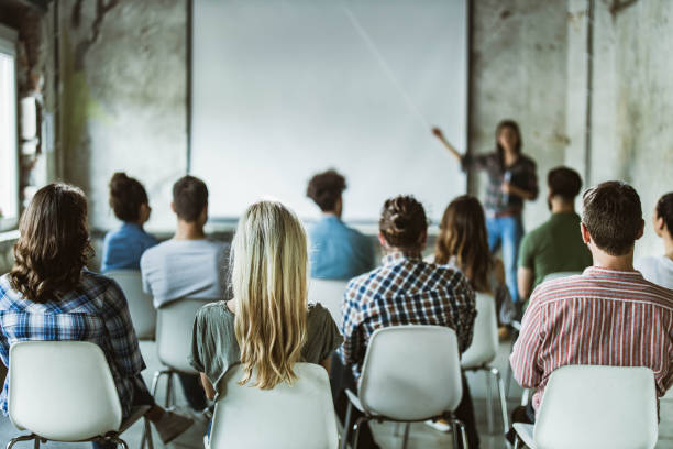 istock Back view of design professionals having training class in the office. 1199194222