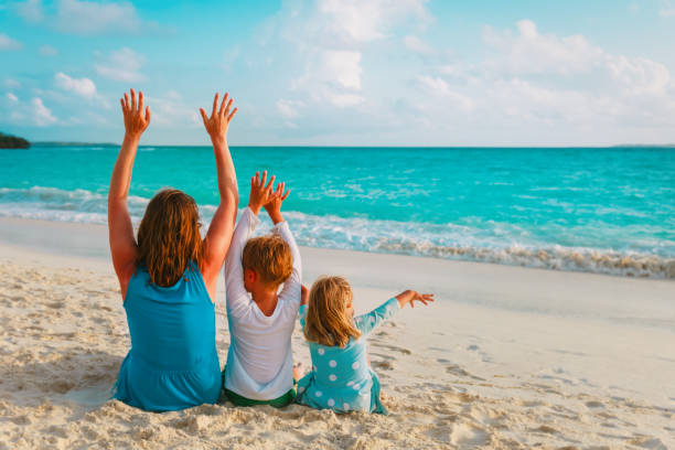 istock happy mother with son and daughter on beach 1199194901