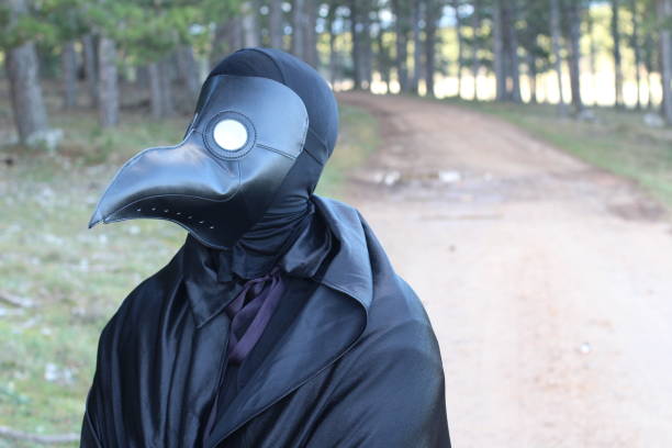 istock Spooky man with crow mask 1199195969