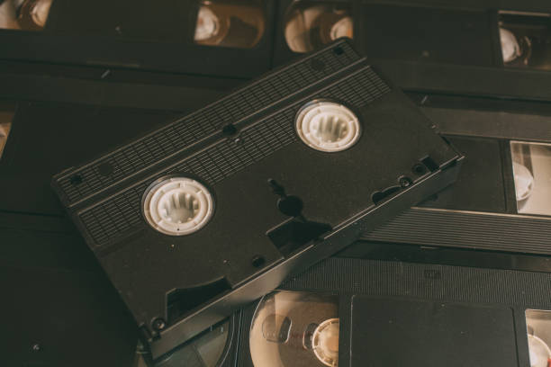 Stack of VHS video tapes as background. Old video cassette tapes. Retro technology. Stack of VHS video tapes as background. Old videocassette tapes. Retro technology. audio cassette blank vcr film reel stock pictures, royalty-free photos & images