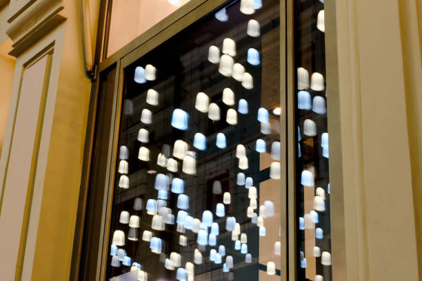 istock Yellow and blue lanterns are reflected in the night window. 1199204382