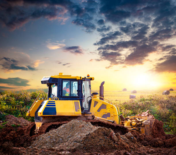 istock Bulldozer at a construction site against the setting sun. 1199205244