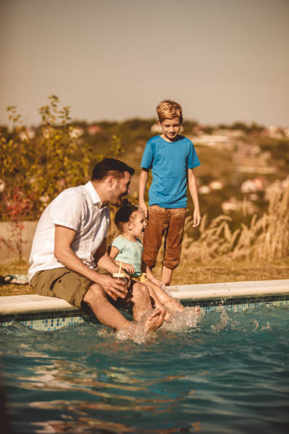 istock Awesome family time by the pool during a sunny day 1199207399