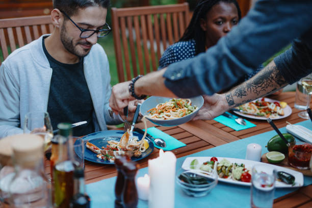 istock Friends enjoying vegan dinner together 1199209692