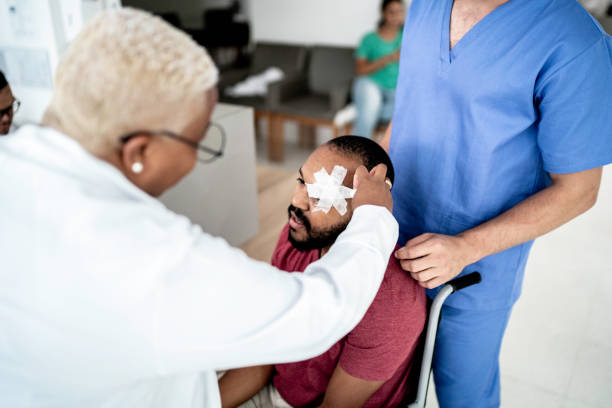 Doctor examining wheelchair patient after eye surgery Doctor examining wheelchair patient after eye surgery bandage stock pictures, royalty-free photos & images