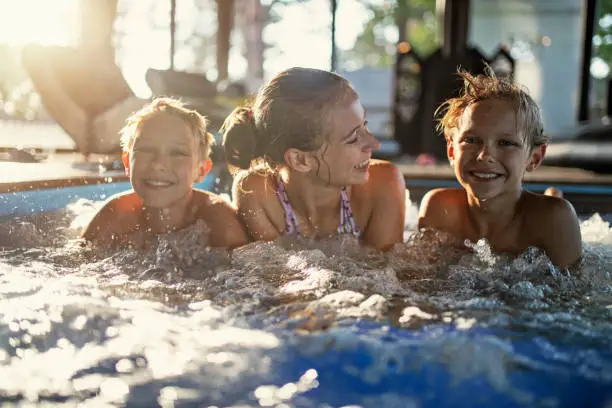 Photo of Kids enjoying swimming at indoors swimming pool