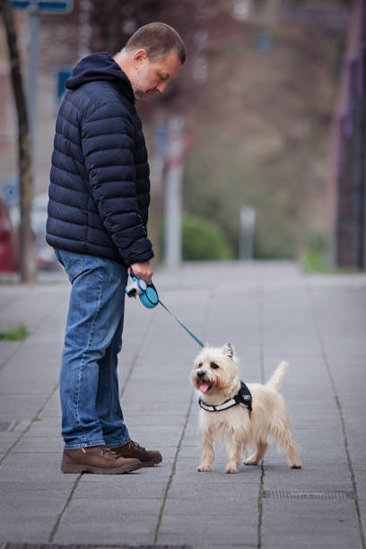 istock Mature man walks with a dog 1199213136