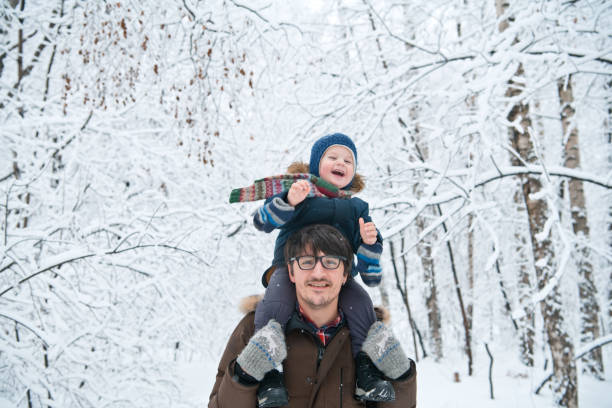 Little boy and father in winter park