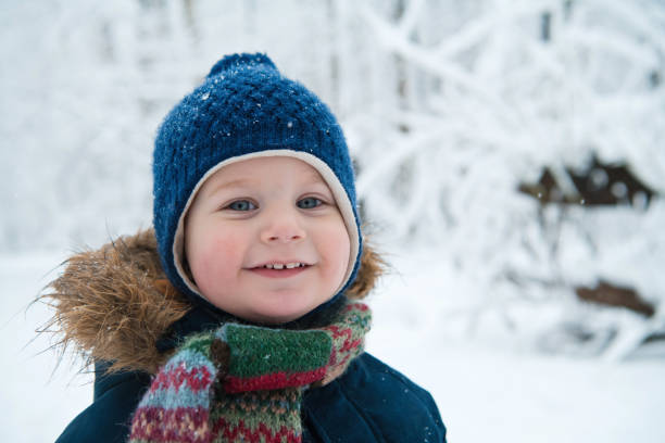 Happy child in winter forest stock photo